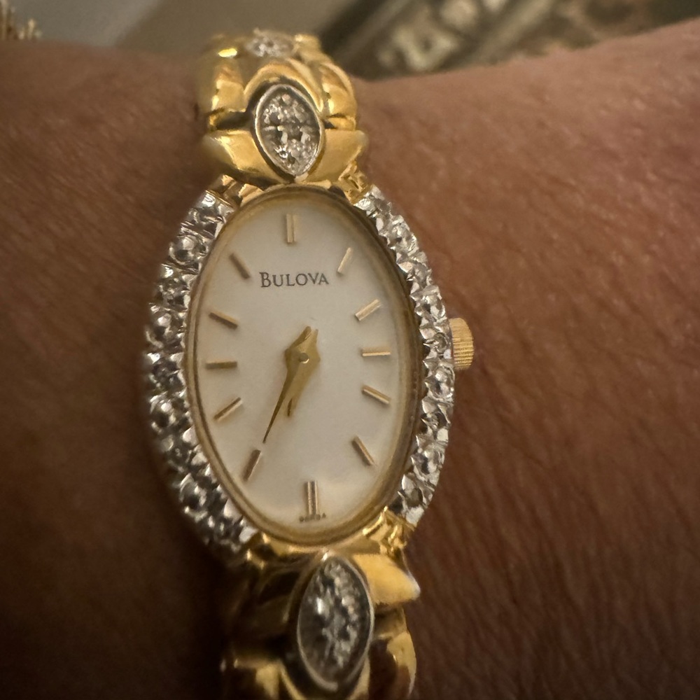 Women gold tone Bulovia watch with diamond accents